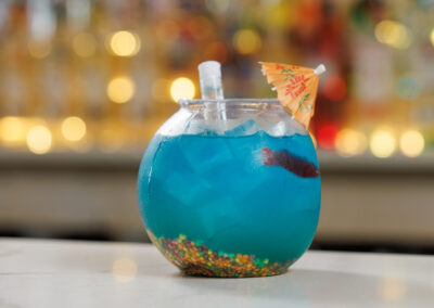 Blue Fishbowl cocktail drink with umbrella and straw