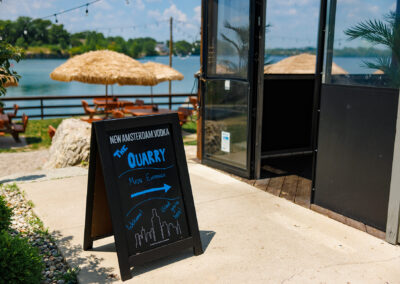 Entrance sign at the quarry restaurant with water in the background
