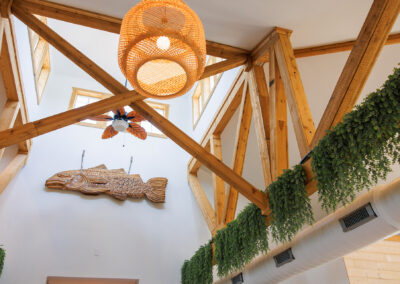 White Interior of Quarry Restaurant with wooden fish on the wall and hanging grass