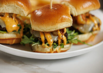 The Quarry restaurant sliders spicy sauce and greens close up