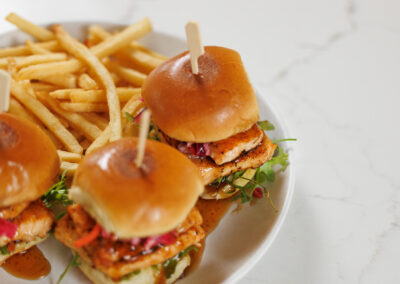 Overhead shot of Salmon sliders and fries at the bar