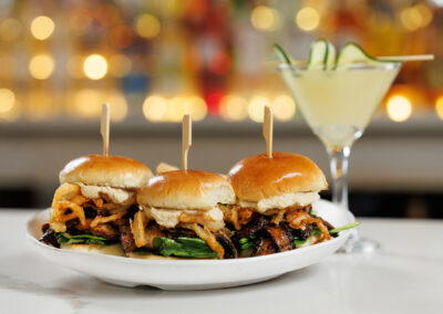 Sliders at the bar and cucumber martini with blurry background