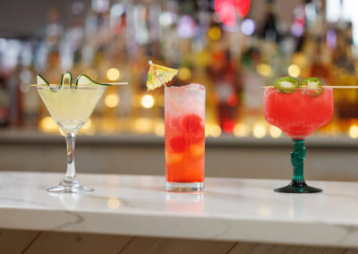 summer drinks lined up at the bar with blurry background